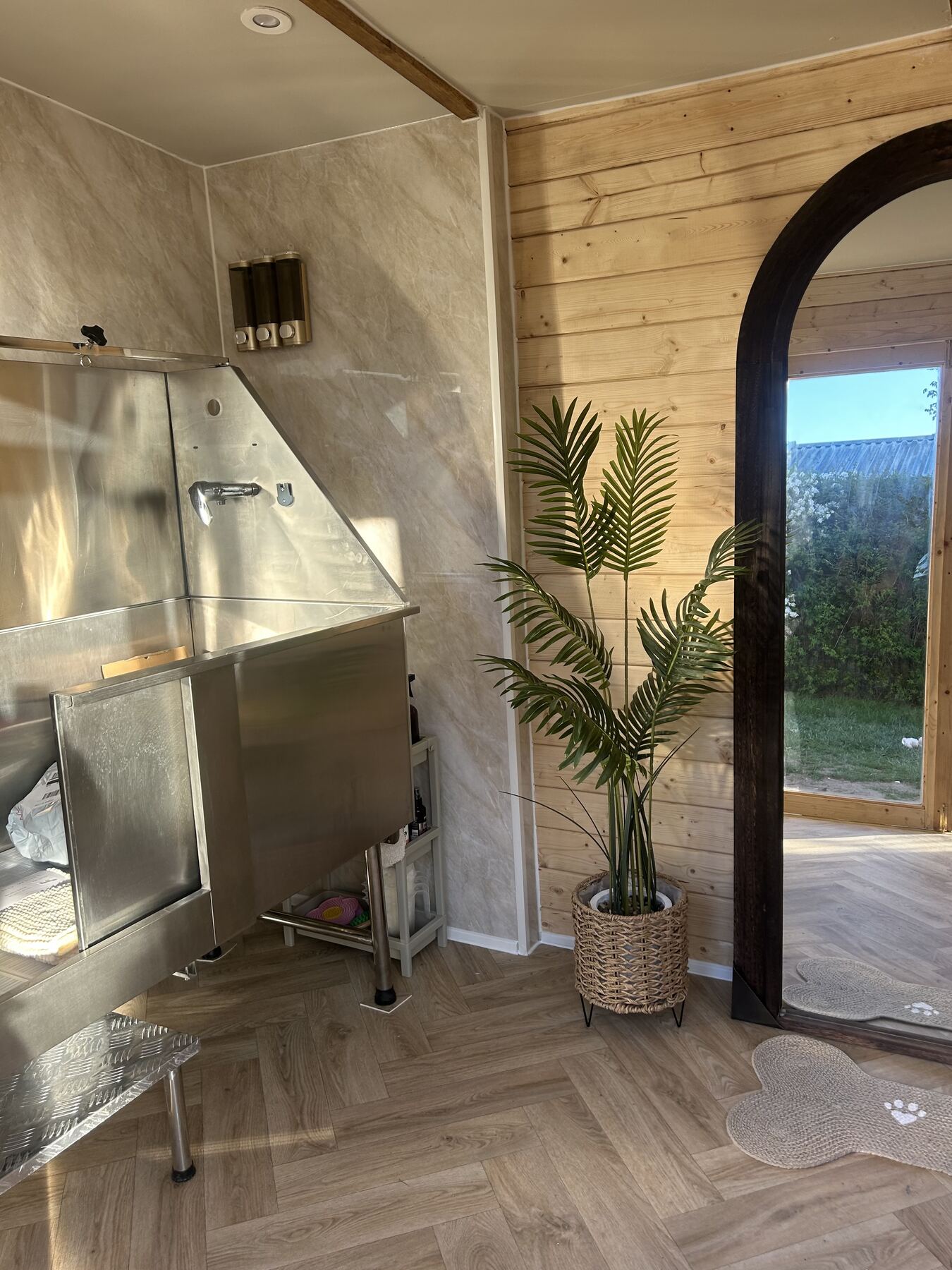 Grooming bath and arched window looking out to the garden